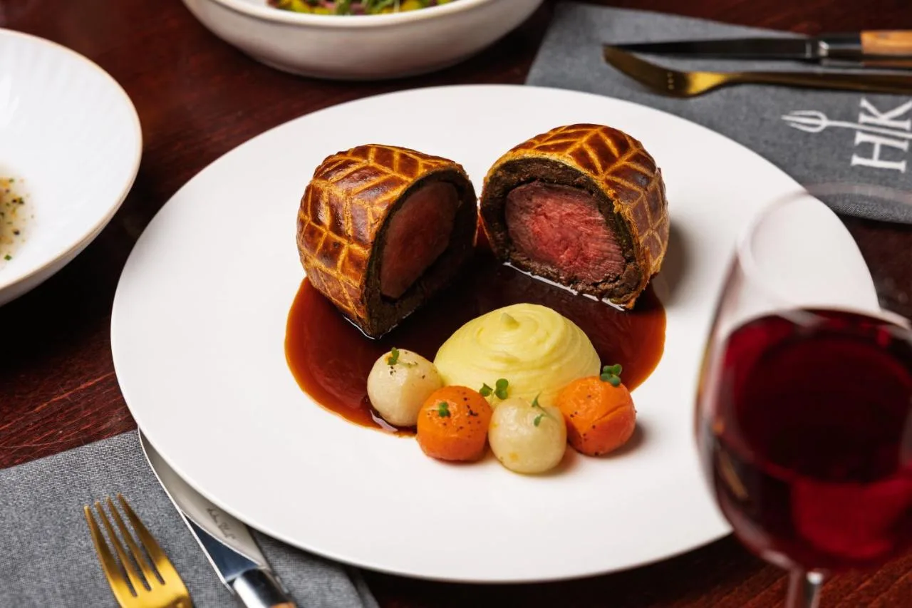 A plate of food with meat and vegetables at The Cumberland, London