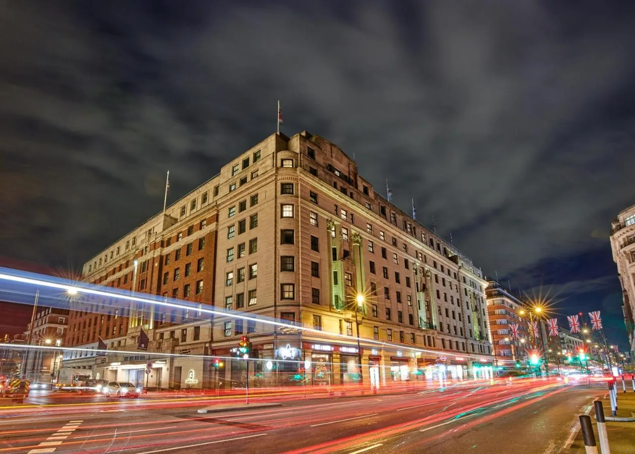 The Cumberland hotel building lit up at night in central London