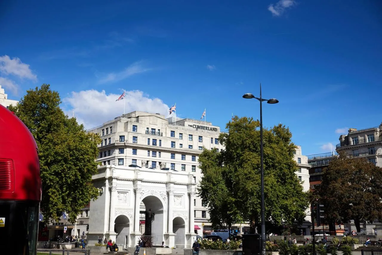 A white building with a flag on top near Hyde Park, London